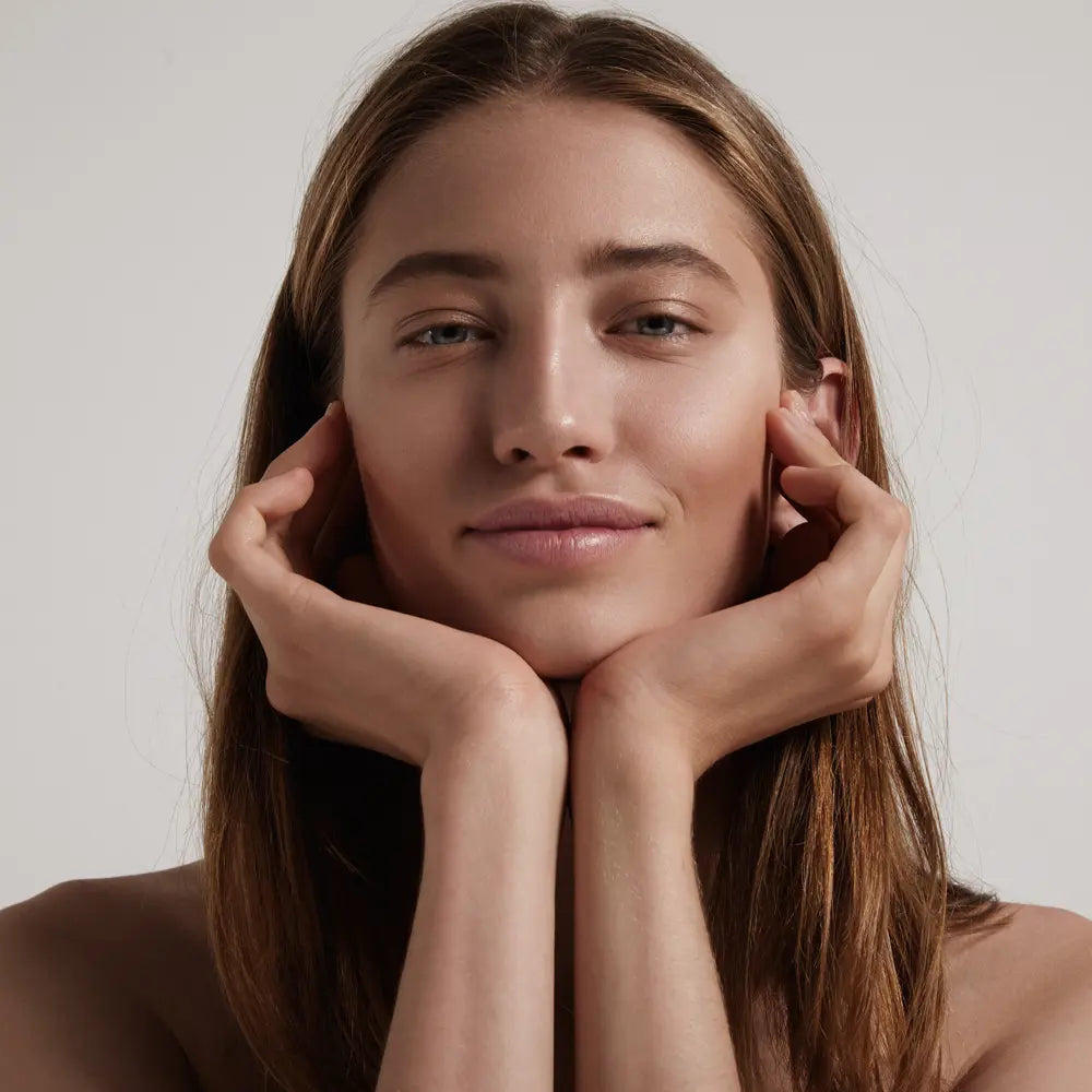 woman holding her face with both hands