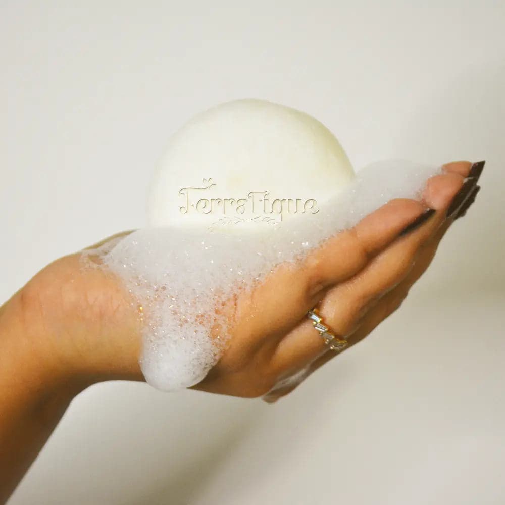 woman holding terrafique rice water shampoo bar