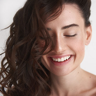 closeup of woman smiling with beautiful hair