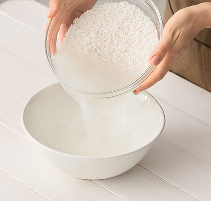 woman pouring rice in a bowl