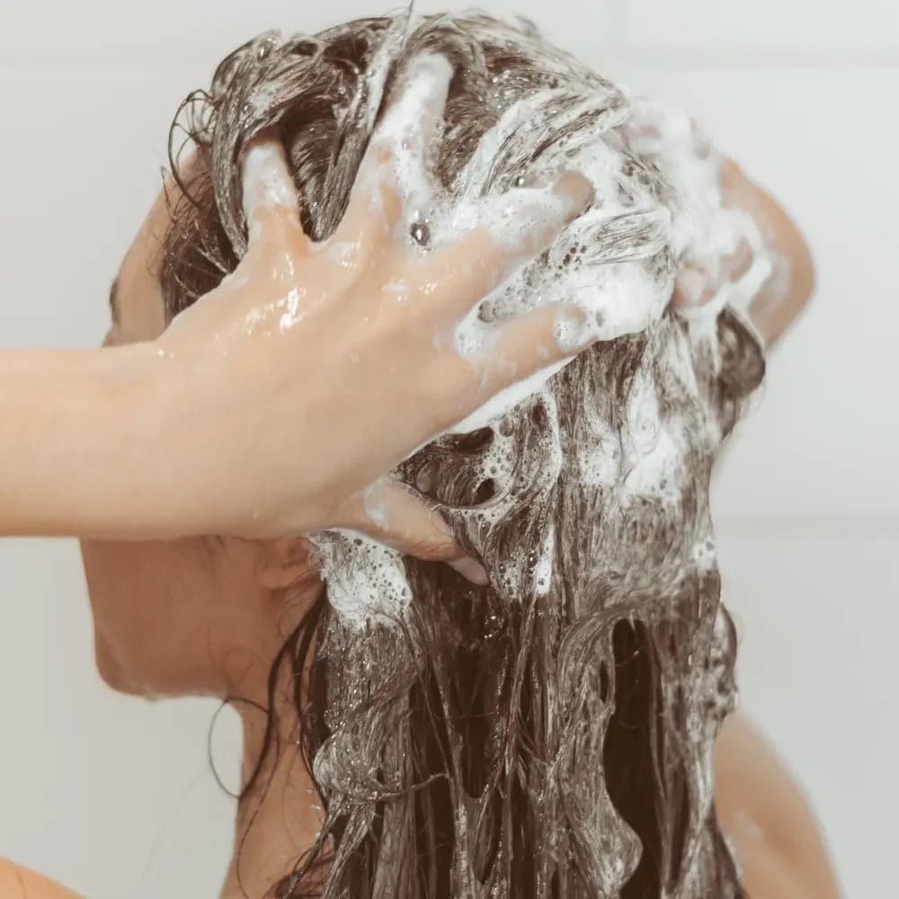 woman shampooing her hair